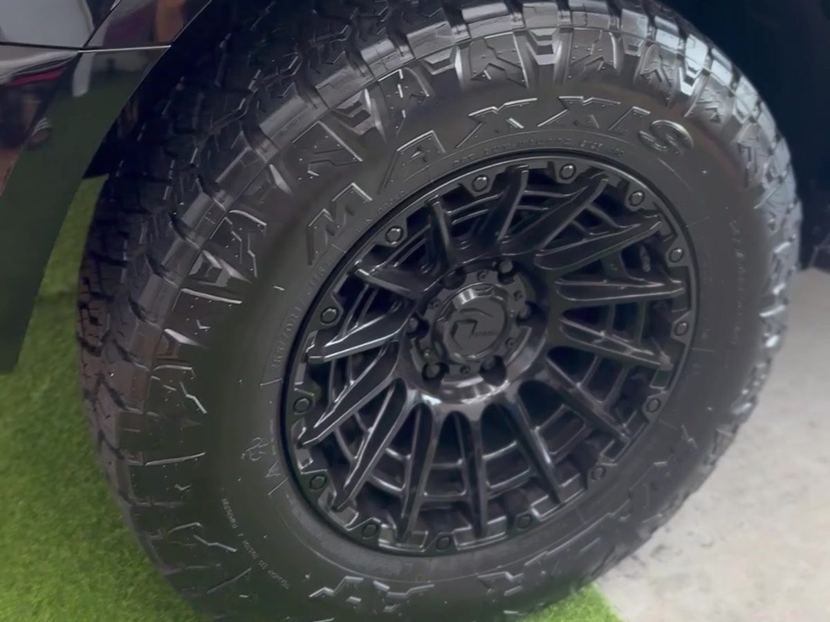 Black alloy wheel and all-terrain tyre, cleaned and dressed